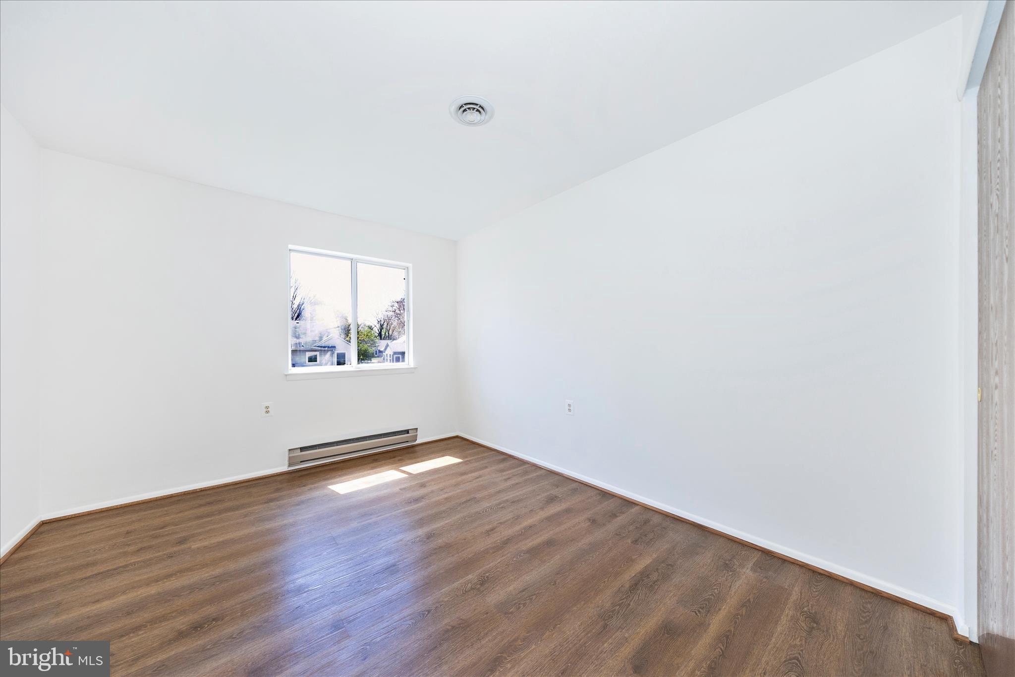 5738 Box Elder Court Frederick, MD 21703 - Photo 23 of 50 an empty room with wooden floor and windows