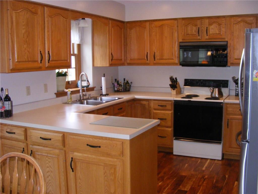 304 Kozy Corner Road Valencia, PA 16059 - Photo 6 of 23 Kitchen With Hickory Floors, Oak Cabinets and Stainless Appliances