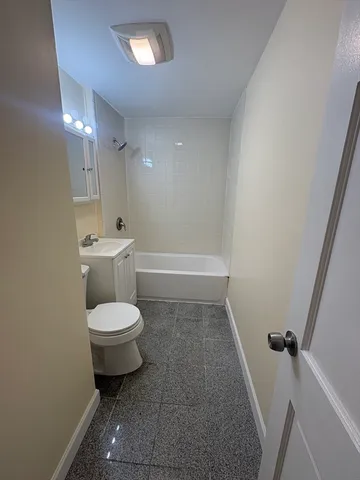 a bathroom with a toilet sink and bathtub