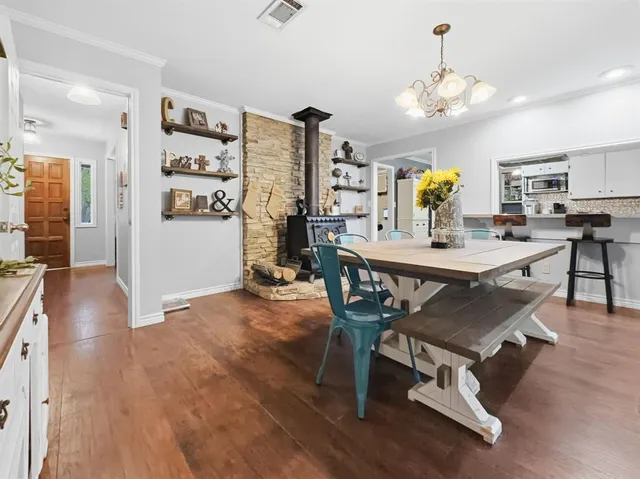 a dining room with furniture and wooden floor