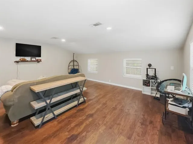 a bedroom with furniture and a flat screen tv