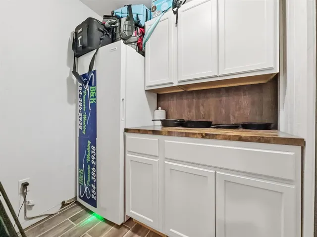 a view of a closet with wooden floor