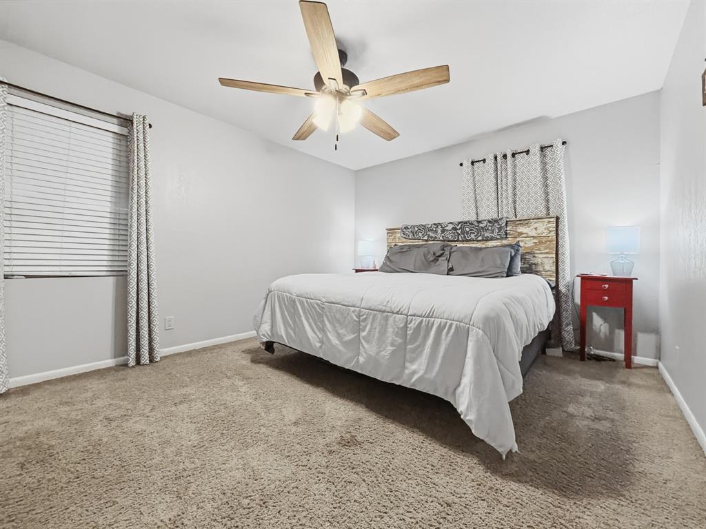 206 Navajo Trail Hamilton, TX 76531 - Photo 24 of 39 Carpeted bedroom with ceiling fan and baseboards