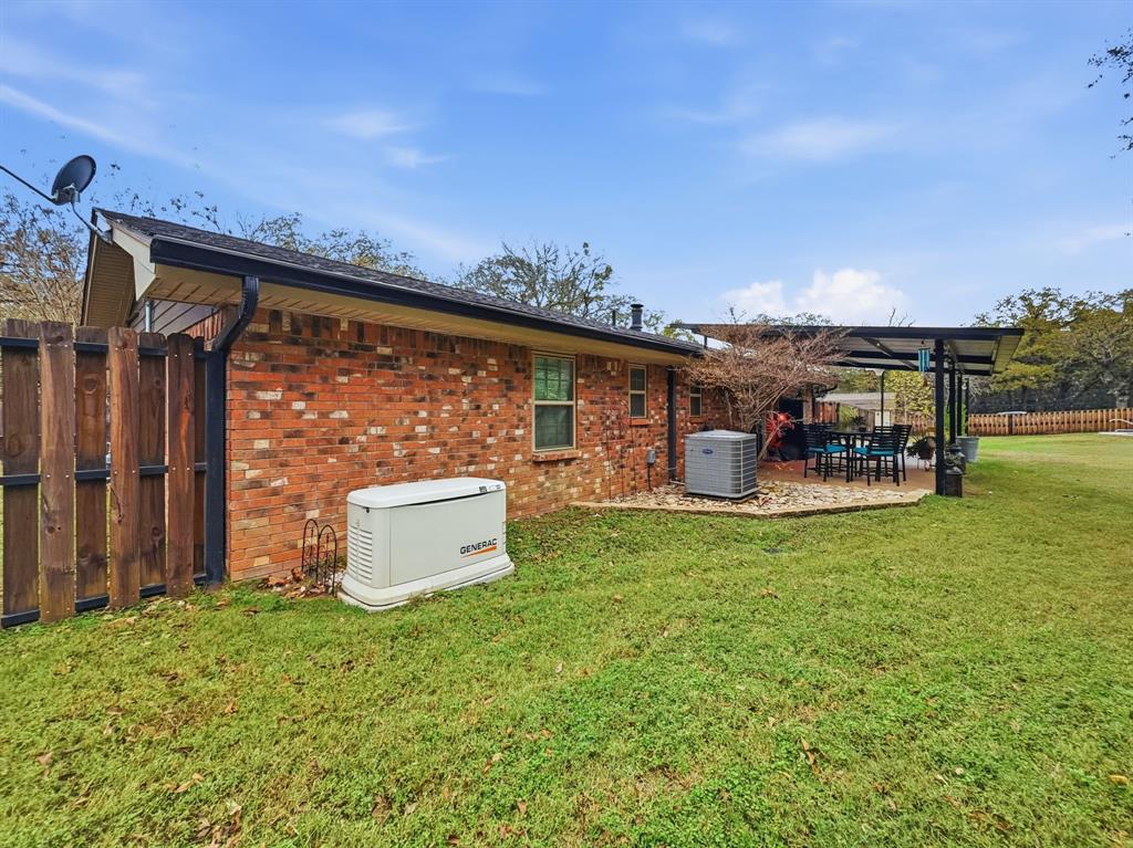206 Navajo Trail Hamilton, TX 76531 - Photo 26 of 39 Rear view of property with a patio area and brick siding
