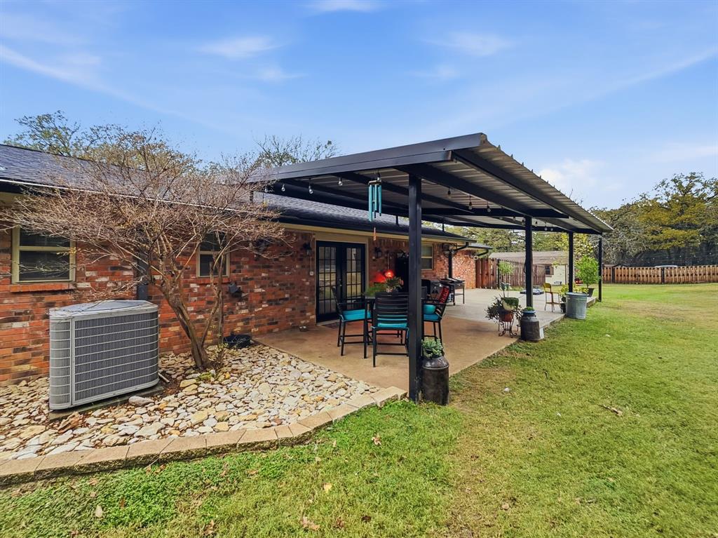 206 Navajo Trail Hamilton, TX 76531 - Photo 27 of 39 Back of house featuring a patio area, french doors, and brick siding