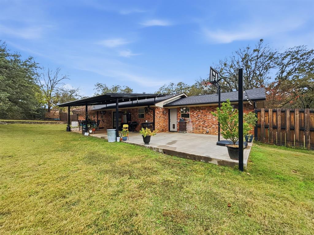 206 Navajo Trail Hamilton, TX 76531 - Photo 28 of 39 Rear view of house with a patio area and brick siding
