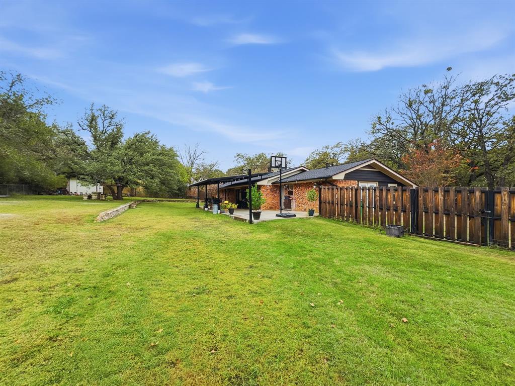 206 Navajo Trail Hamilton, TX 76531 - Photo 29 of 39 Fenced backyard with a patio area