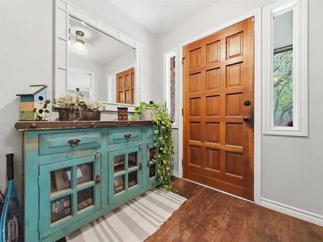 a room with a dresser and a window