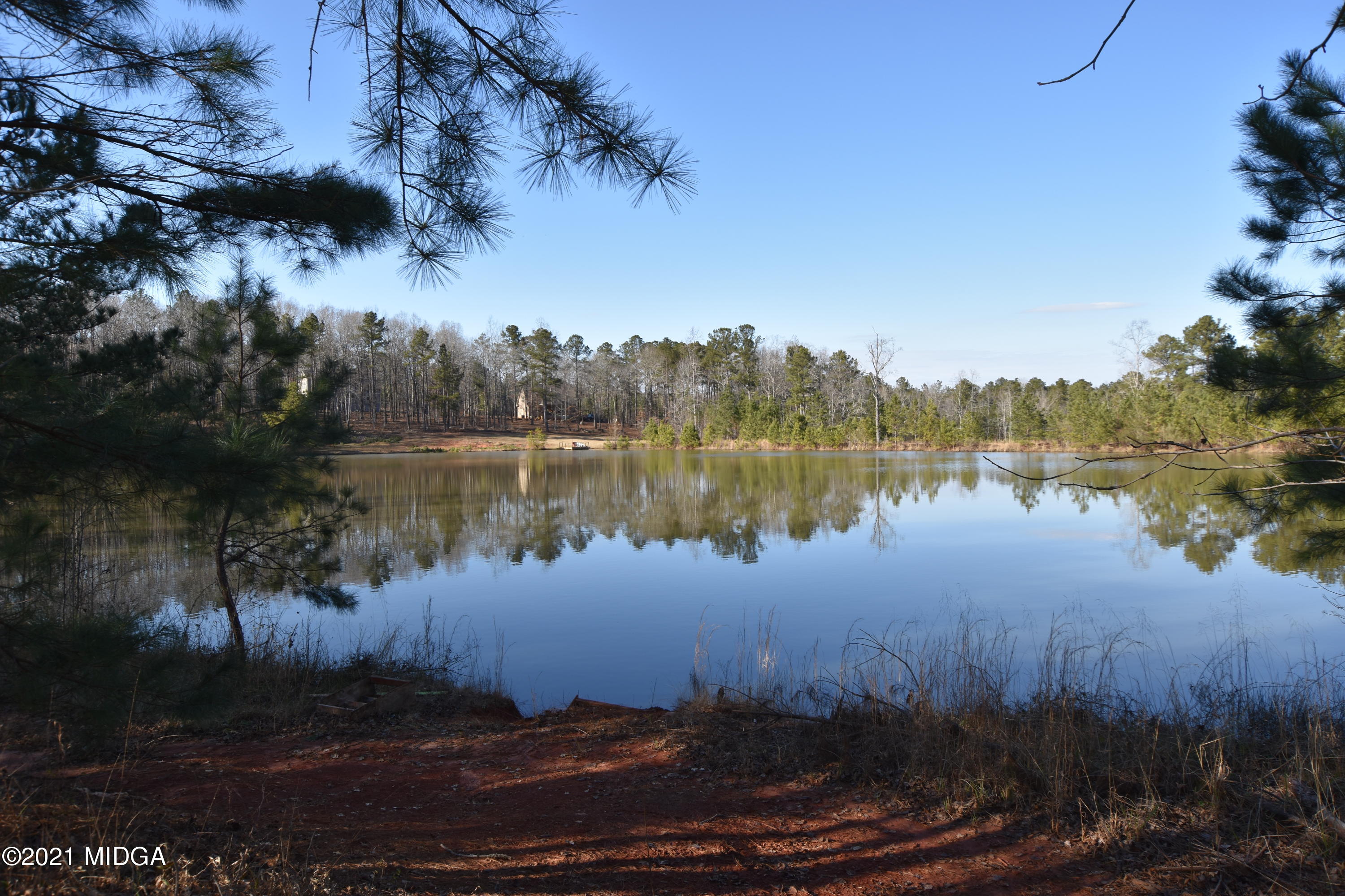Lot 18 Plentitude Church Road Gray, GA 31032 - Photo 7 of 9 a view of a lake in between the house and trees all around