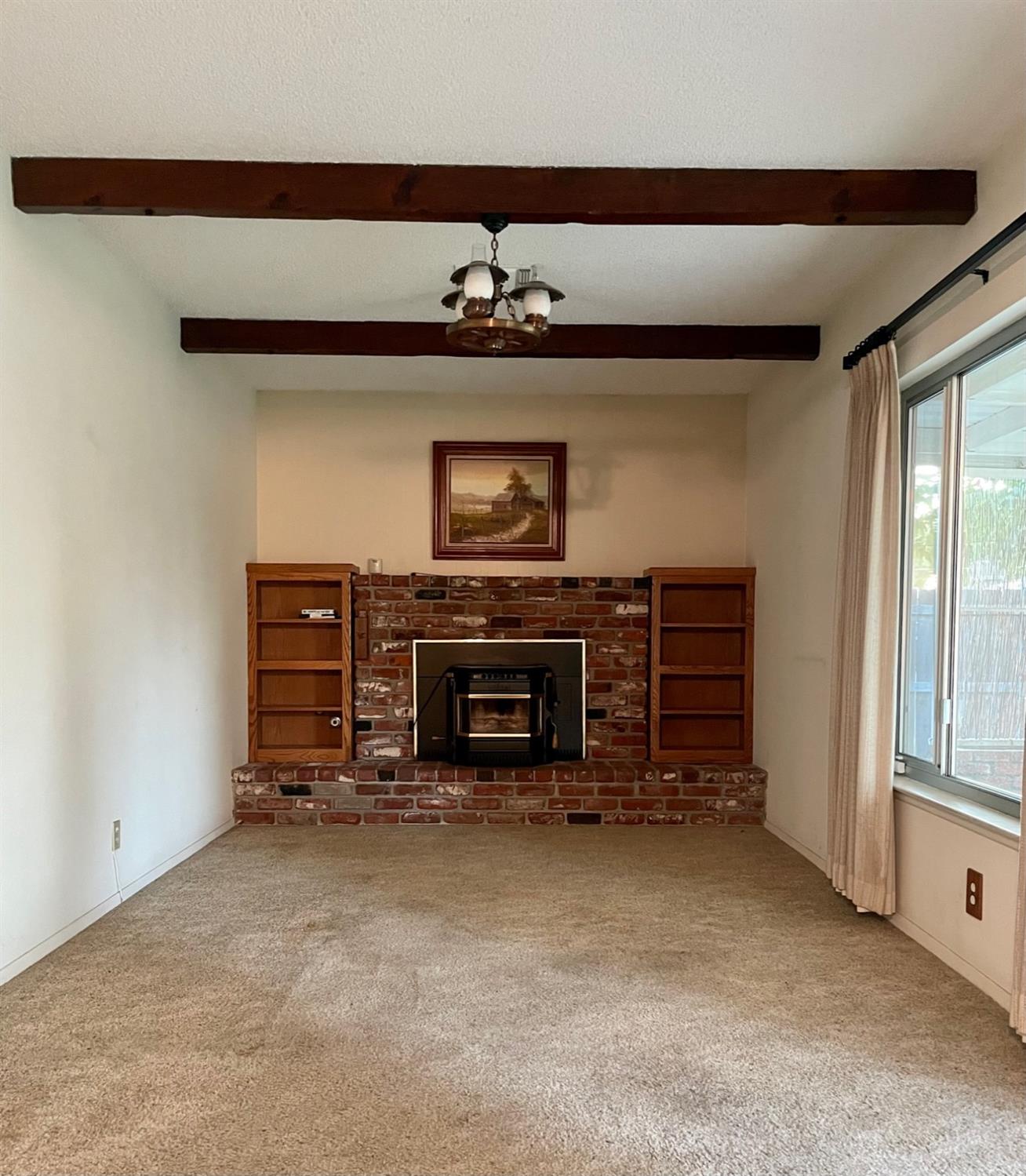 230 West Spring Lane Lemoore, CA 93245 - Photo 11 of 14 a view of an empty room with a fireplace