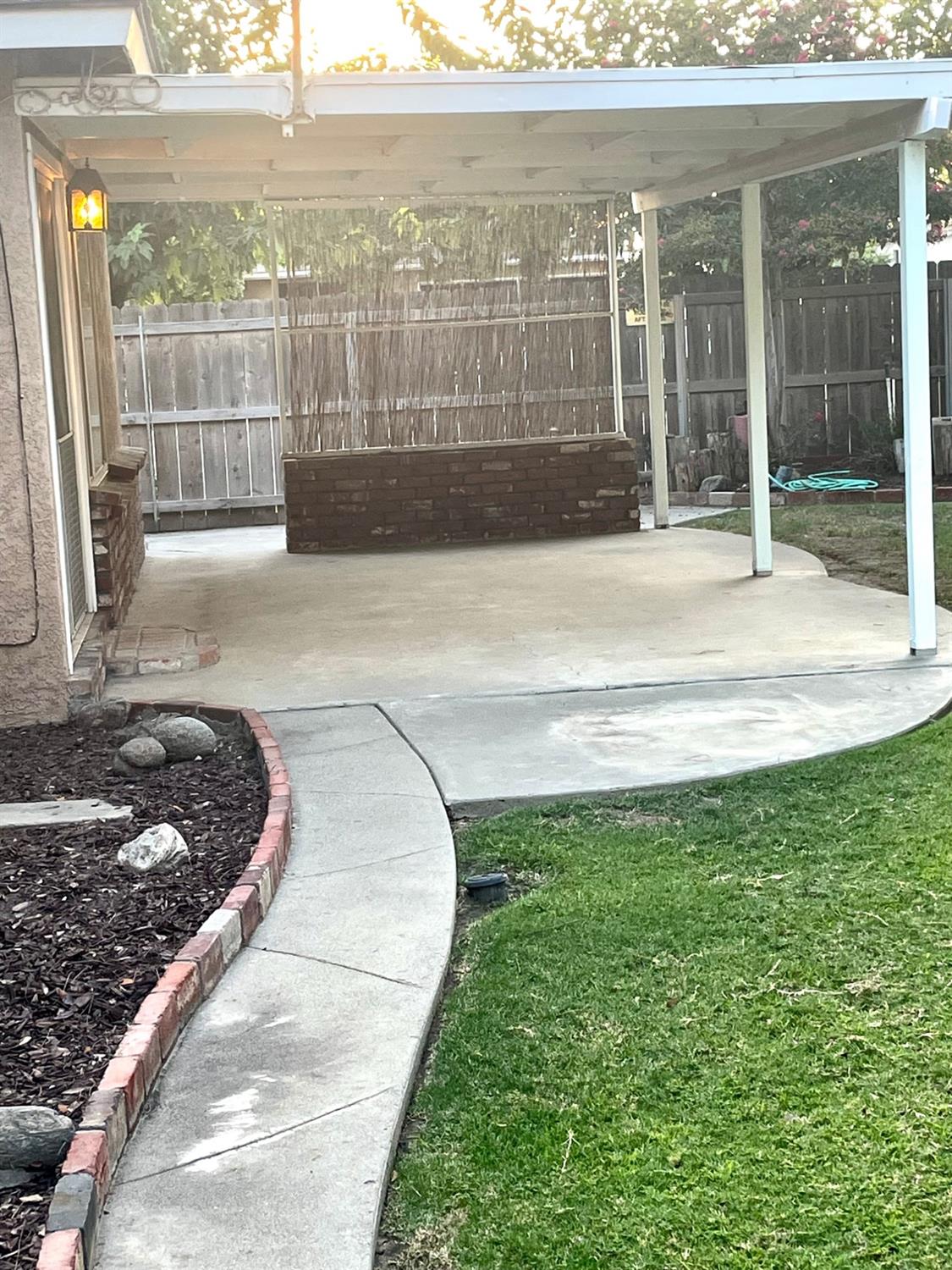 230 West Spring Lane Lemoore, CA 93245 - Photo 12 of 14 a view of a balcony with a floor to ceiling window and wooden fence