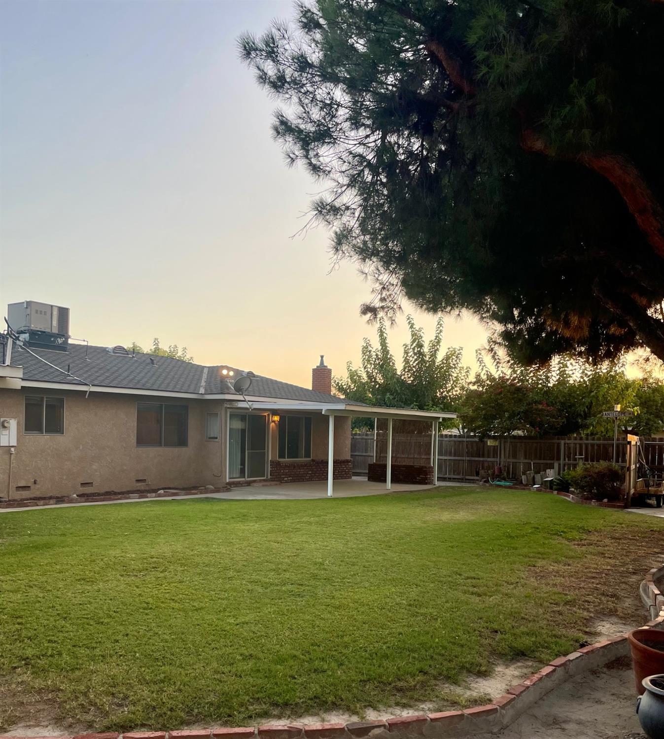 230 West Spring Lane Lemoore, CA 93245 - Photo 14 of 14 a view of a house with a backyard
