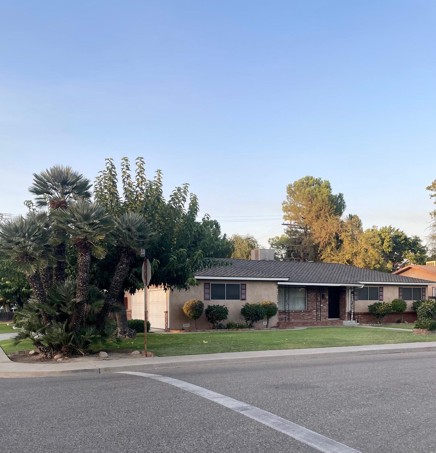 230 West Spring Lane Lemoore, CA 93245 - Photo 2 of 14 a front view of a house with a yard and trees