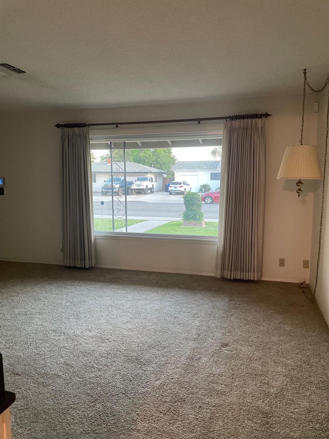 230 West Spring Lane Lemoore, CA 93245 - Photo 3 of 14 an empty room with window