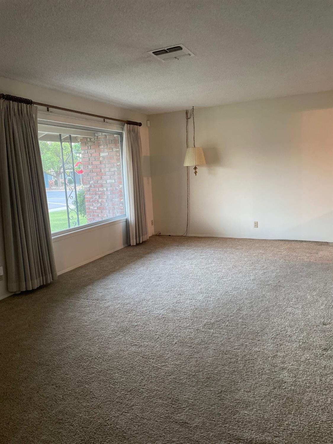 230 West Spring Lane Lemoore, CA 93245 - Photo 4 of 14 an empty room with a empty space and windows