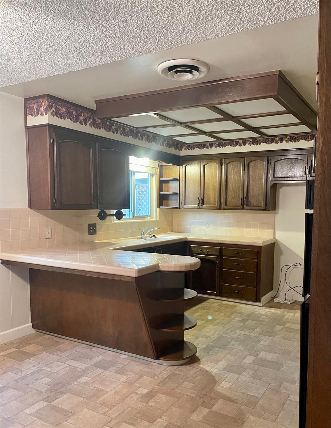 230 West Spring Lane Lemoore, CA 93245 - Photo 5 of 14 a kitchen with a stove and a sink