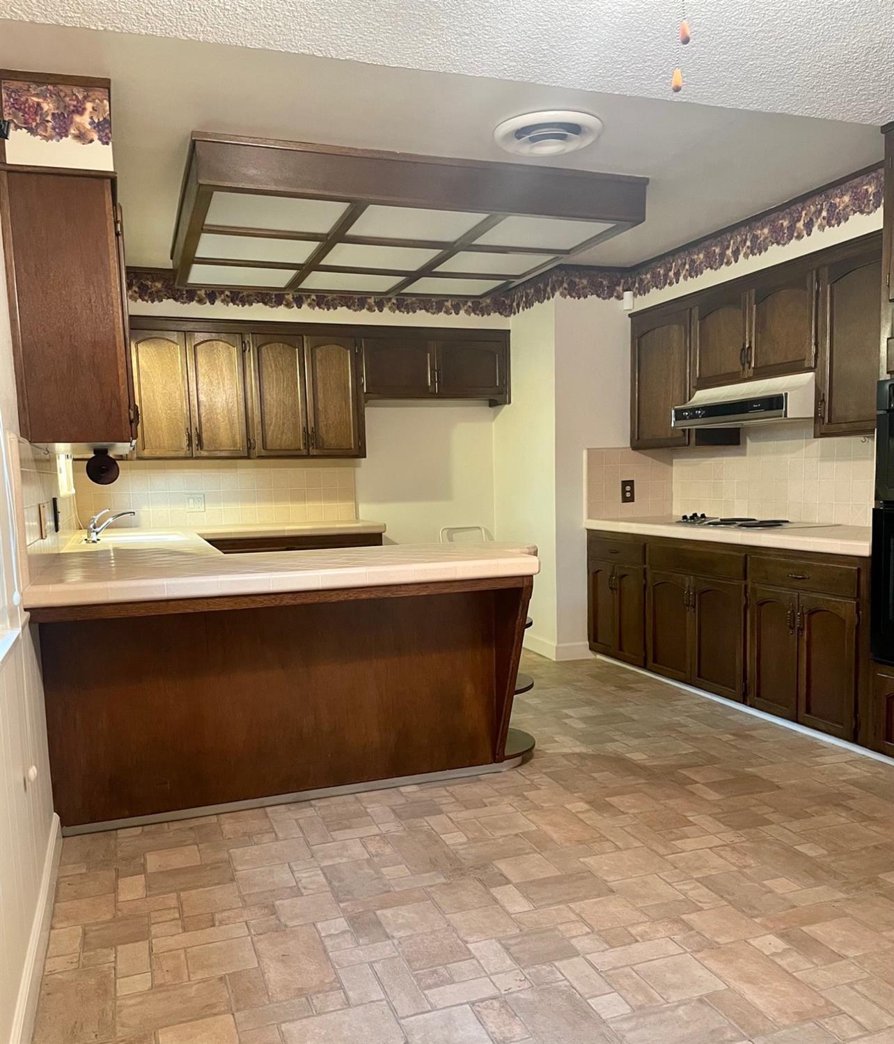230 West Spring Lane Lemoore, CA 93245 - Photo 6 of 14 a kitchen with a sink and cabinets