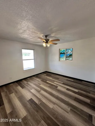 a view of a livingroom with a ceiling fan and window