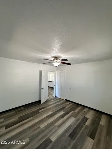 a view of a room with an empty space and a ceiling fan