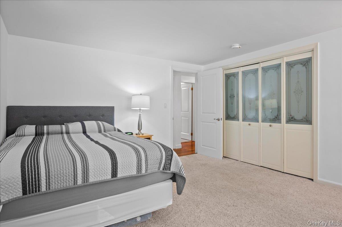 105 High St Extension Mount Kisco, NY 10549 - Photo 24 of 38 a bedroom with a large bed and a window