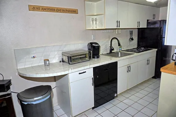 a kitchen with a sink and cabinets