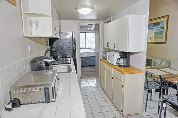 a kitchen with sink refrigerator and stove