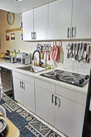 a utility room with sink dryer and washer