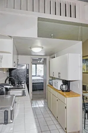 a kitchen with a stove a refrigerator and cabinets