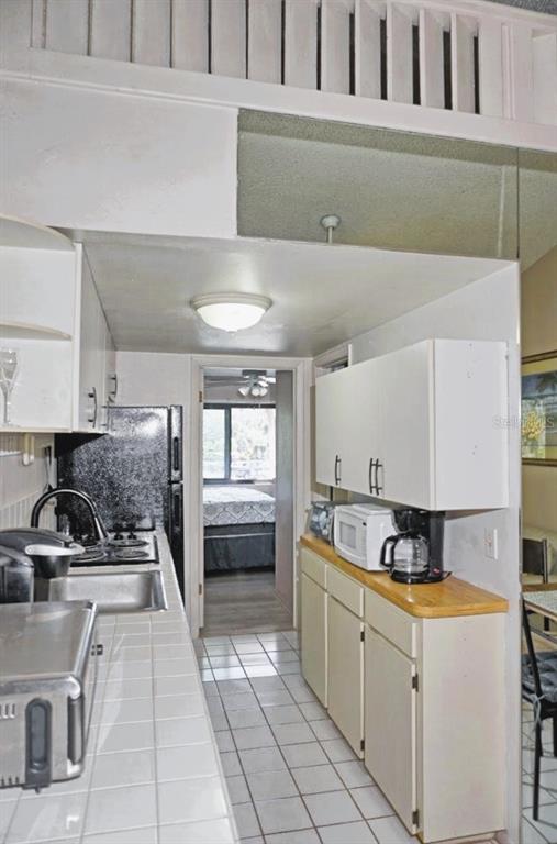 20893 Haulover Cove Road, Unit 8 Lutz, FL 33558 - Photo 15 of 35 a kitchen with a stove a refrigerator and cabinets