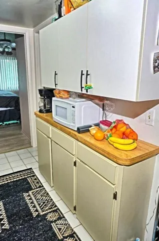 a bedroom with a bed a couch and dresser