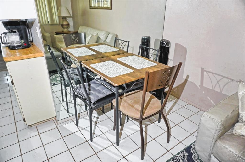 20893 Haulover Cove Road, Unit 8 Lutz, FL 33558 - Photo 16 of 35 a dining room with furniture and wooden floor