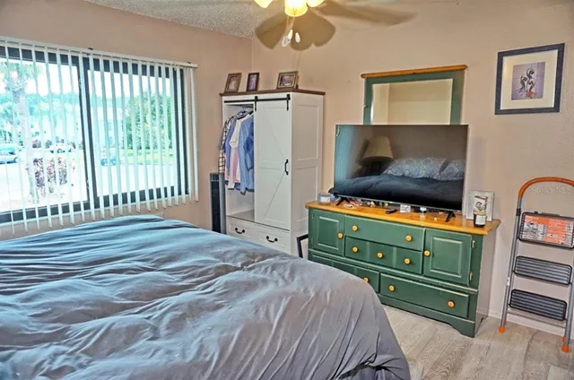 a bedroom with a bed and a television
