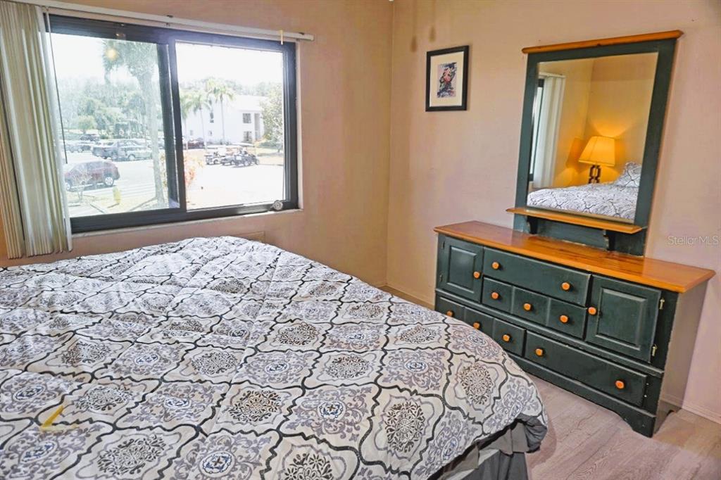 20893 Haulover Cove Road, Unit 8 Lutz, FL 33558 - Photo 19 of 35 a bedroom with a bed dresser and window