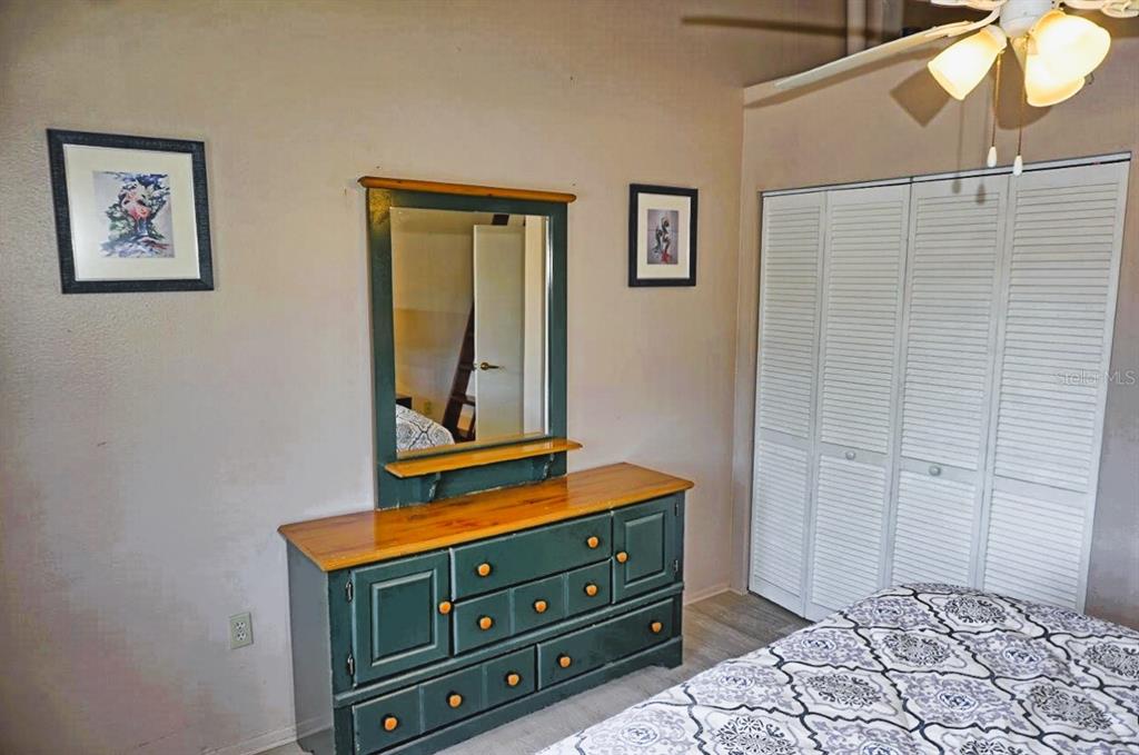 20893 Haulover Cove Road, Unit 8 Lutz, FL 33558 - Photo 21 of 35 a room with a dresser and a mirror
