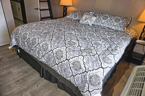 a bed sitting in a bedroom next to a window