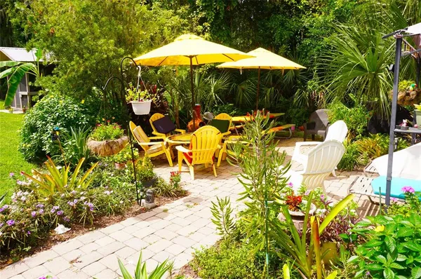 a view of a swimming pool with a table and chairs under an umbrella