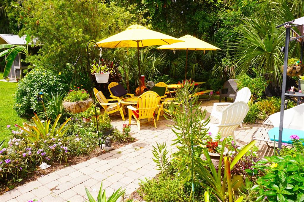 20893 Haulover Cove Road, Unit 8 Lutz, FL 33558 - Photo 25 of 35 a view of a swimming pool with a table and chairs under an umbrella