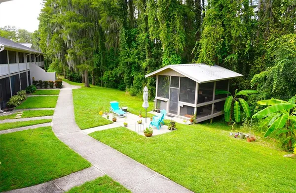 a view of a house with backyard sitting area and garden