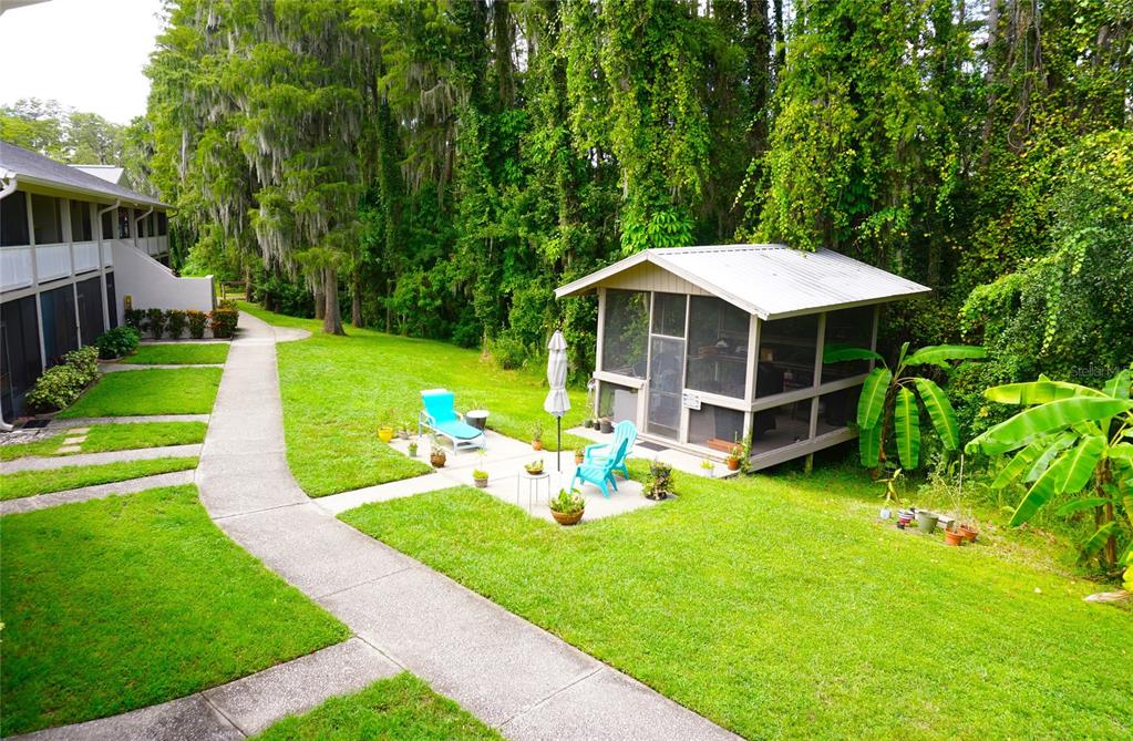 20893 Haulover Cove Road, Unit 8 Lutz, FL 33558 - Photo 26 of 35 a view of a house with backyard sitting area and garden