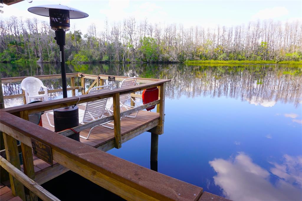 20893 Haulover Cove Road, Unit 8 Lutz, FL 33558 - Photo 32 of 35 a view of a lake with a deck