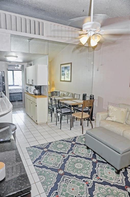 20893 Haulover Cove Road, Unit 8 Lutz, FL 33558 - Photo 6 of 35 a living room with furniture and a chandelier