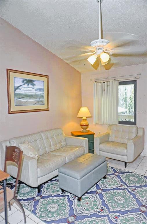 20893 Haulover Cove Road, Unit 8 Lutz, FL 33558 - Photo 8 of 35 a living room with furniture and a chandelier