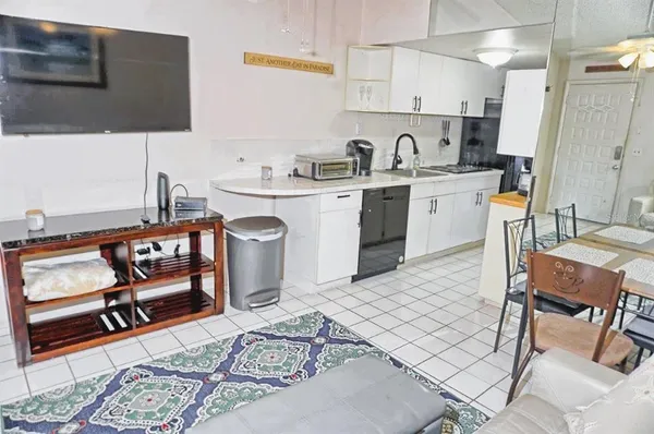 a kitchen with a sink cabinets and window