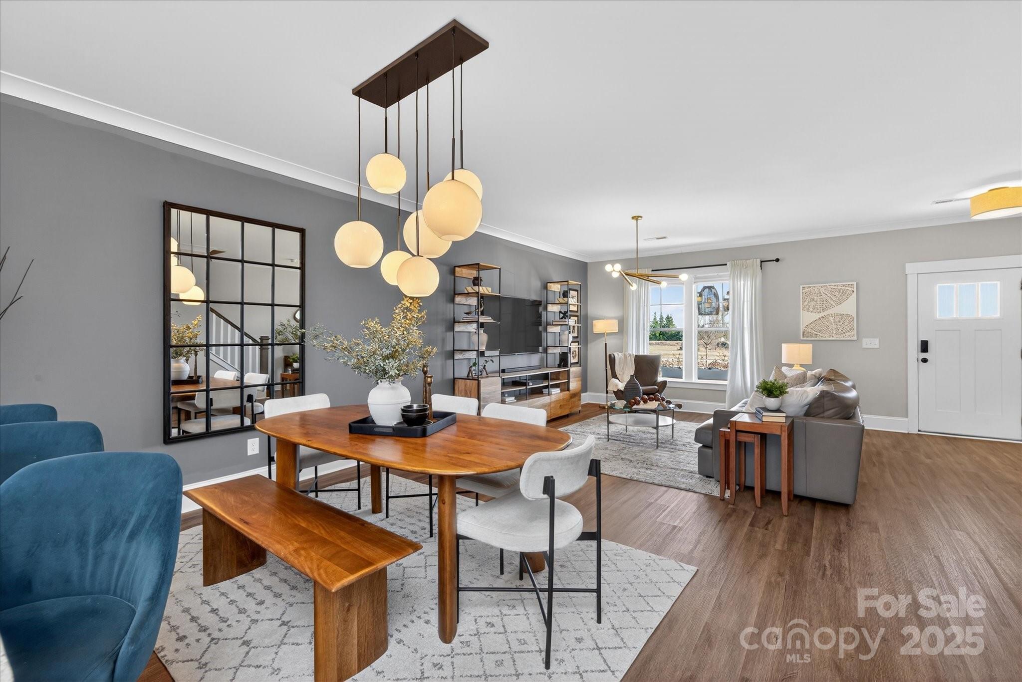 676 Dunkins Ferry Road Rock Hill, SC 29730 - Photo 13 of 47 a dining room with wooden floor a chandelier fan a wooden table and chairs