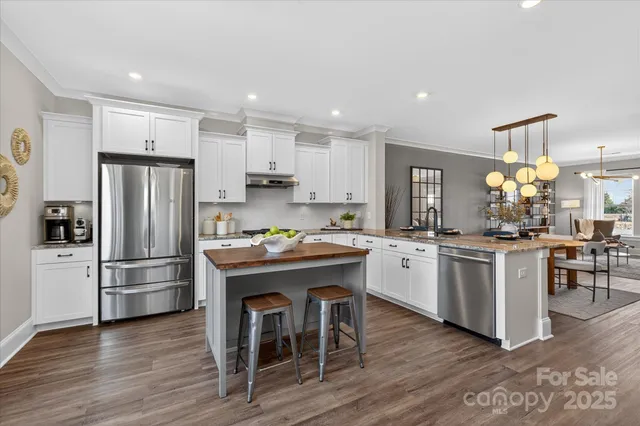 a kitchen with stainless steel appliances granite countertop a stove and a refrigerator