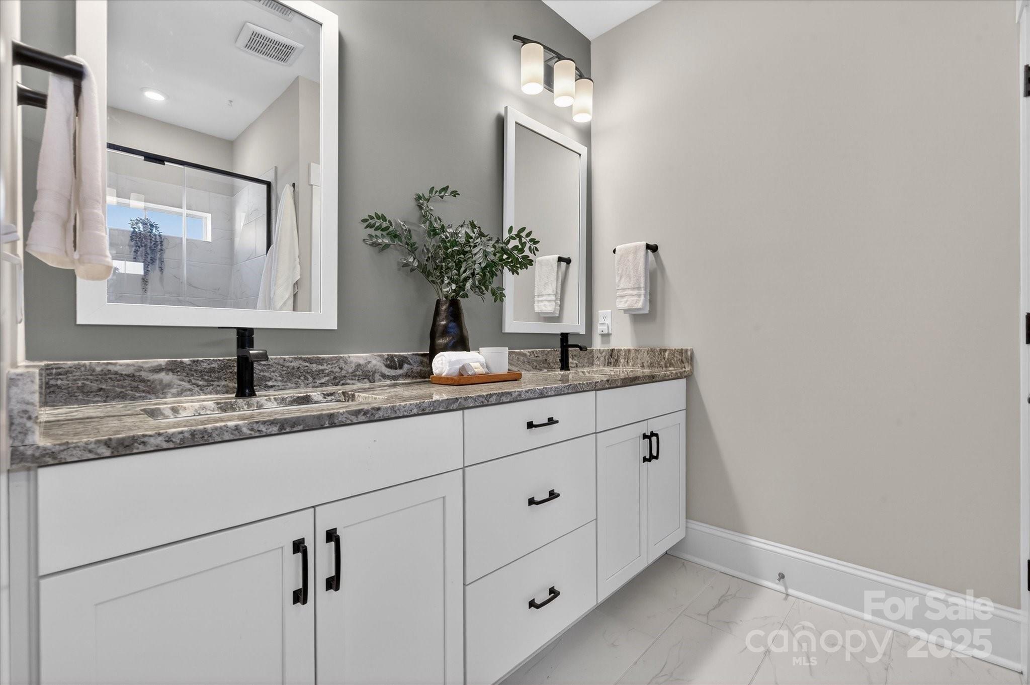 676 Dunkins Ferry Road Rock Hill, SC 29730 - Photo 24 of 47 a bathroom with a granite countertop sink and a mirror