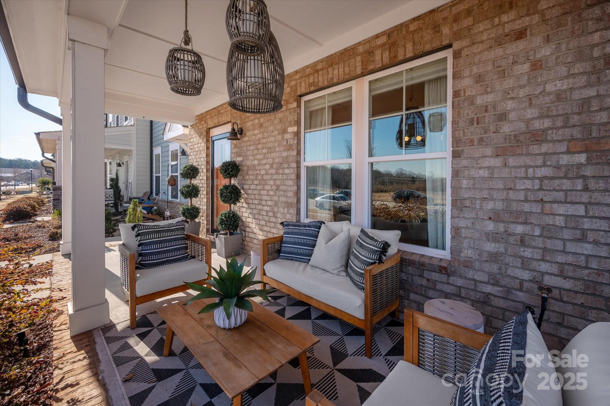 676 Dunkins Ferry Road Rock Hill, SC 29730 - Photo 4 of 47 a view of a patio with couches table and chairs with potted plants