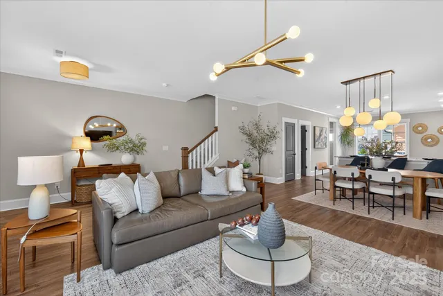 a living room with furniture and a chandelier