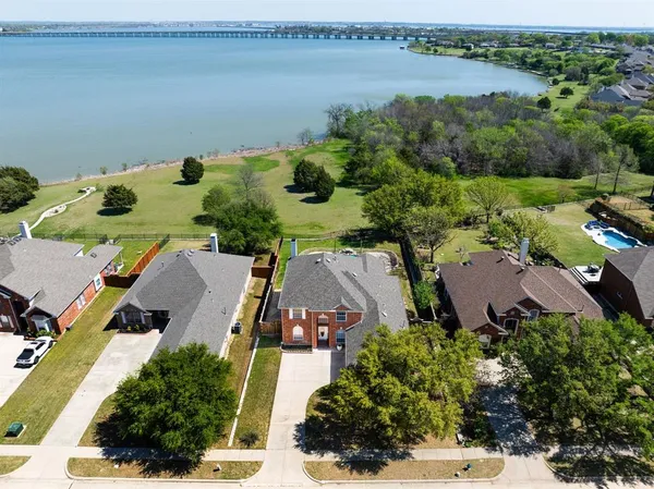 an aerial view of a house with garden space and lake view