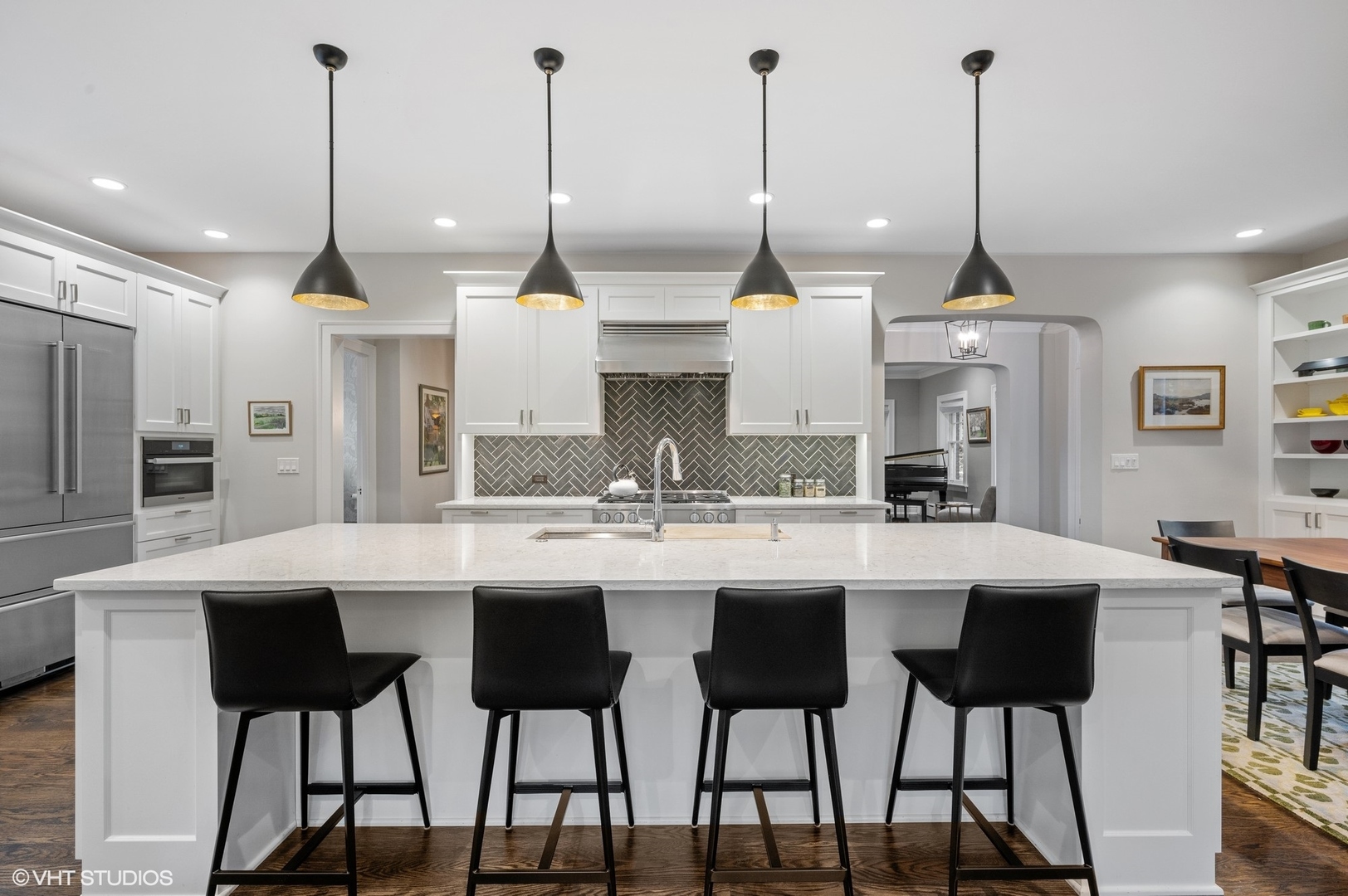 1002 Monroe Avenue River Forest, IL 60305 - Photo 7 of 31 a kitchen with stainless steel appliances kitchen island granite countertop a sink a stove a refrigerator a kitchen island with chairs